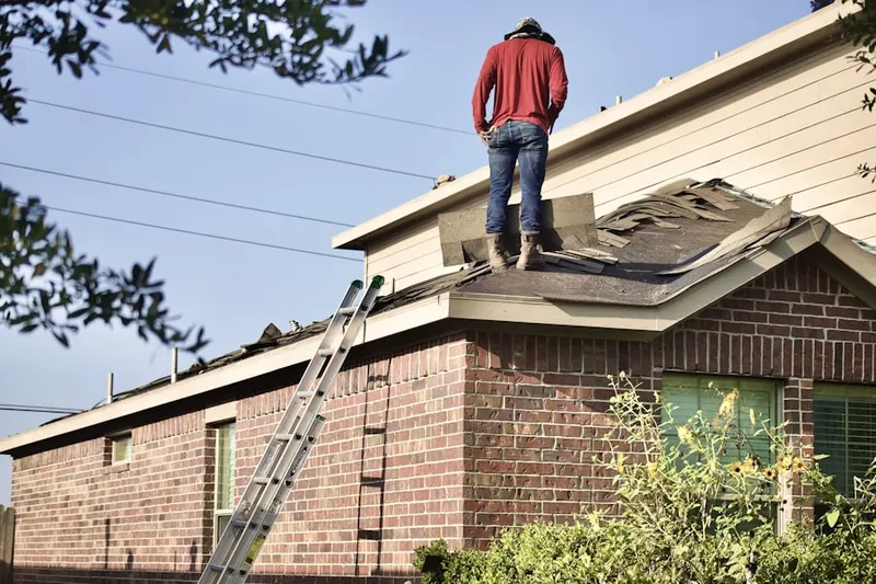 Professional roofer working on a residential roof in Wuthering Heights